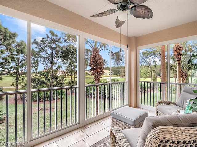 sunroom featuring a wealth of natural light and ceiling fan