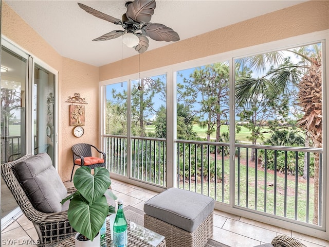 sunroom featuring ceiling fan and a healthy amount of sunlight