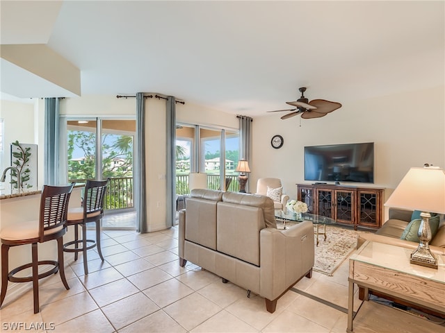 living room featuring ceiling fan and light tile patterned floors