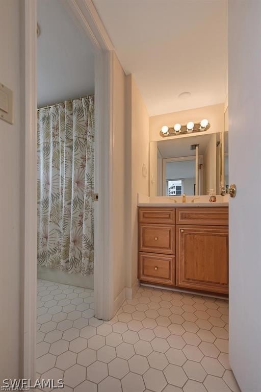 bathroom with oversized vanity and tile flooring