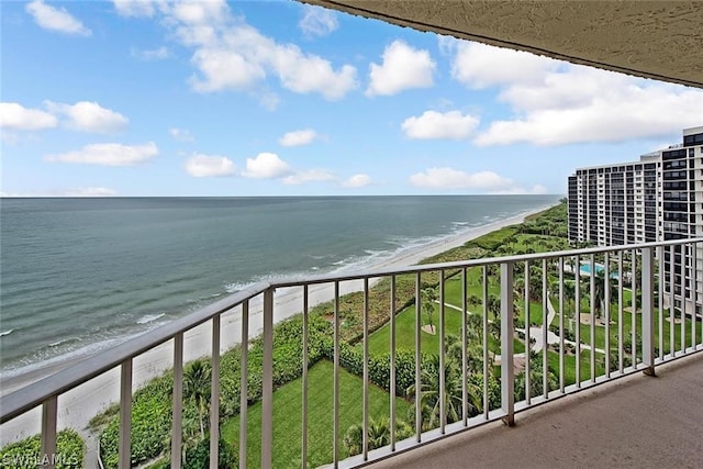 balcony featuring a beach view and a water view