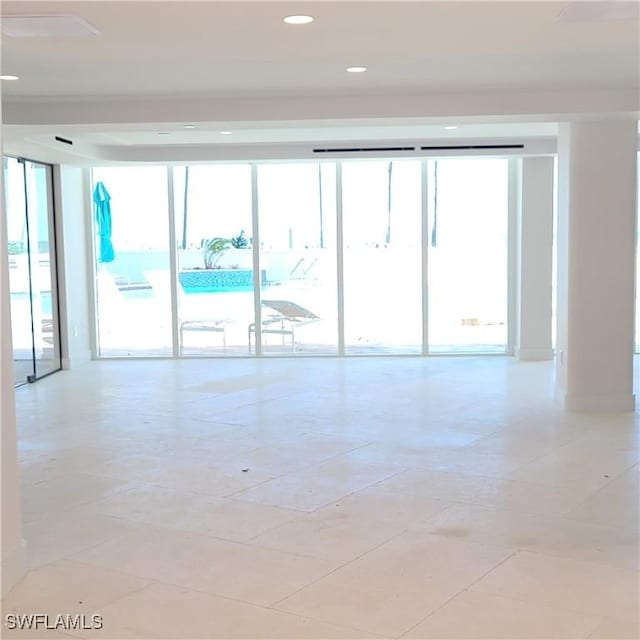 unfurnished room featuring expansive windows and recessed lighting