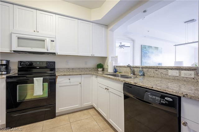 kitchen with white cabinets, light stone countertops, black appliances, and sink