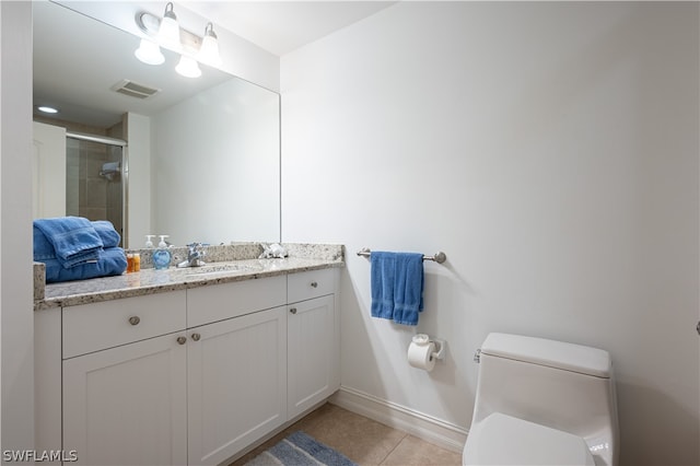 bathroom with toilet, a shower with door, tile flooring, and vanity