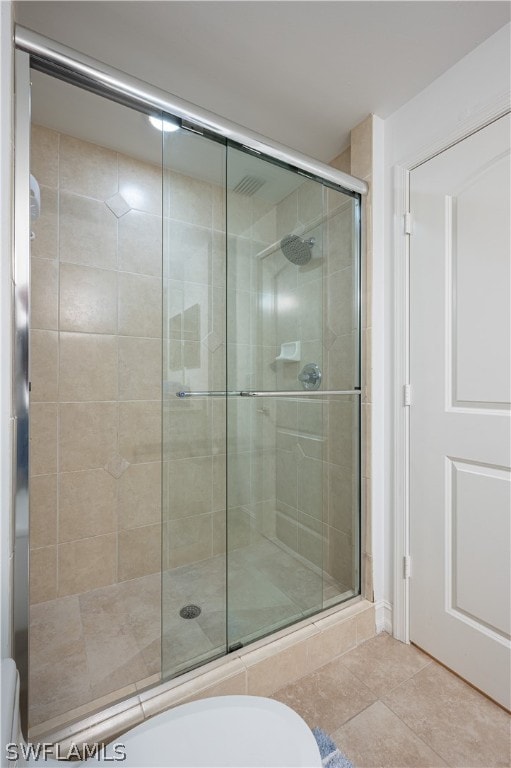 bathroom with walk in shower and tile flooring