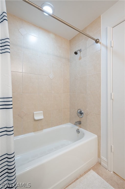 bathroom with tile floors and shower / bath combo with shower curtain