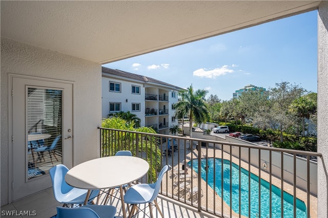 balcony featuring a fenced in pool