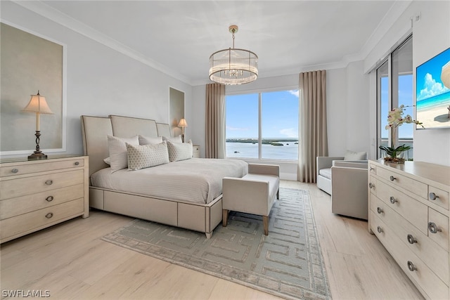 bedroom with a water view, ornamental molding, and light wood-type flooring