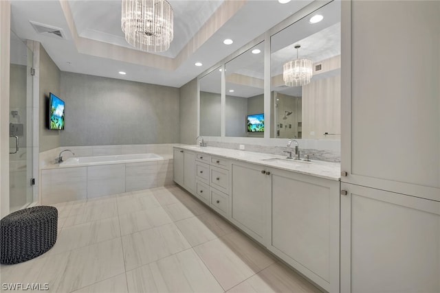 bathroom featuring a raised ceiling, tile floors, dual vanity, and an inviting chandelier