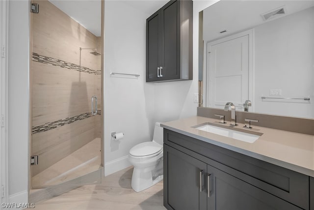 bathroom featuring walk in shower, toilet, and large vanity