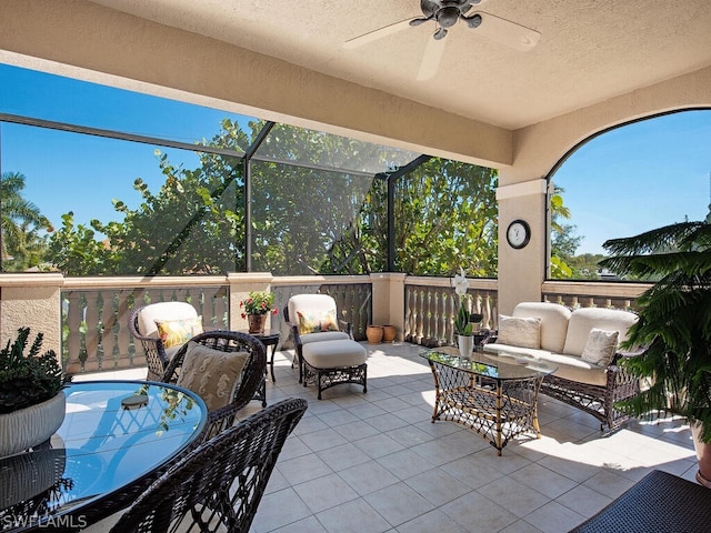 view of patio with a lanai, outdoor lounge area, and ceiling fan