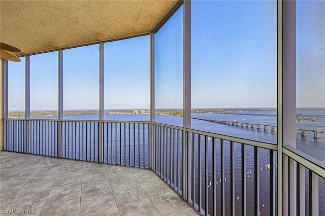 unfurnished sunroom with a water view