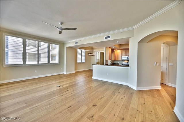 unfurnished living room featuring crown molding, light wood-type flooring, and ceiling fan