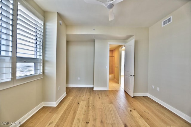 empty room featuring ceiling fan and light hardwood / wood-style floors