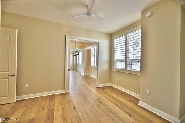 unfurnished room with ceiling fan and light hardwood / wood-style flooring