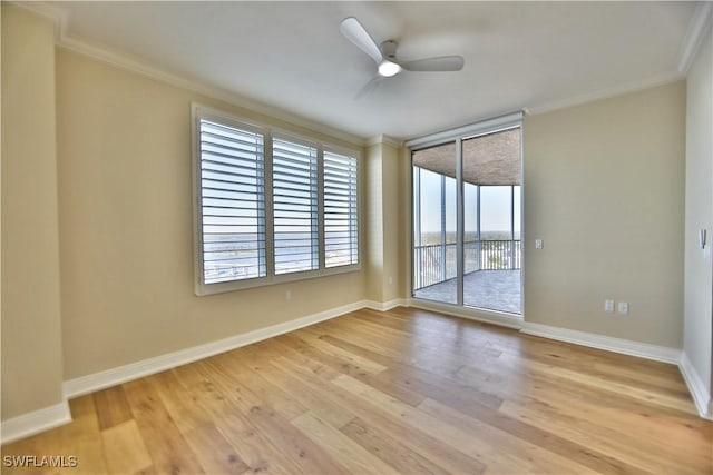 empty room with ceiling fan, crown molding, and light wood-type flooring