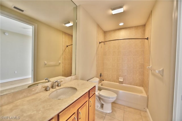 full bathroom featuring tiled shower / bath, tile patterned floors, toilet, and vanity