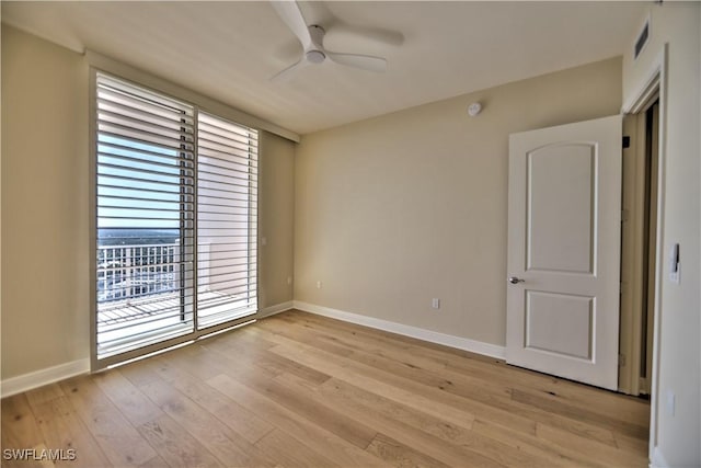 empty room with light hardwood / wood-style flooring and ceiling fan