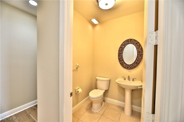 bathroom with tile patterned flooring, sink, and toilet