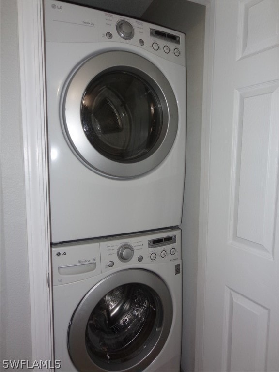 laundry room with stacked washer and dryer