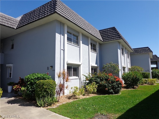 view of home's exterior with a lawn