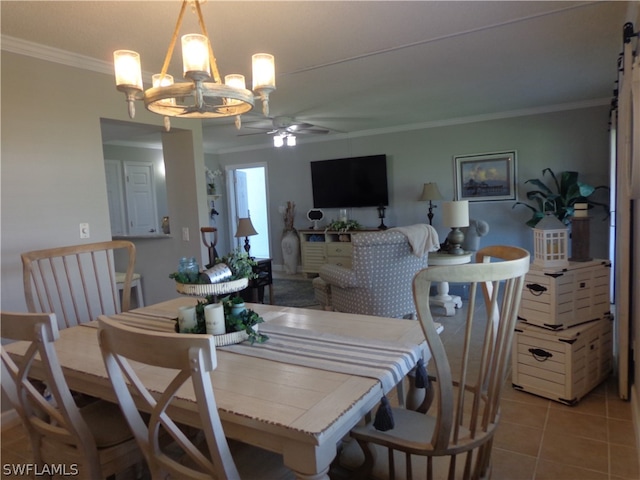 tiled dining area with a barn door, ornamental molding, and ceiling fan with notable chandelier