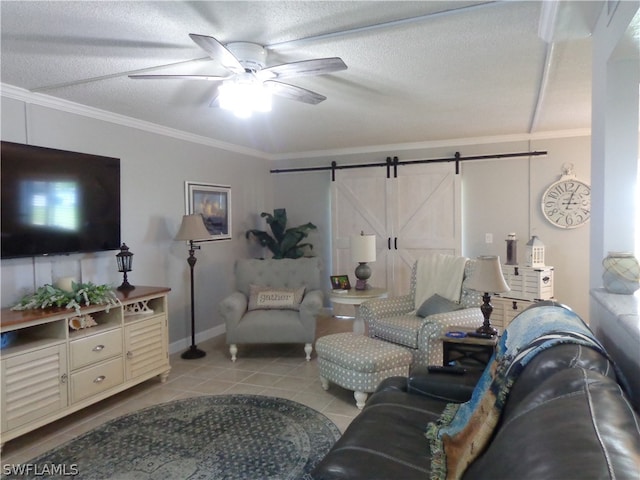 tiled living room with a barn door, ornamental molding, ceiling fan, and a textured ceiling