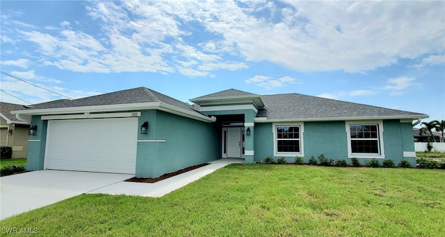 view of front of property with a garage and a front yard