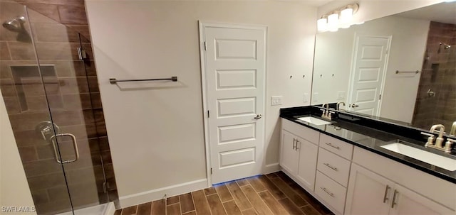 bathroom with vanity, hardwood / wood-style floors, and a shower with door