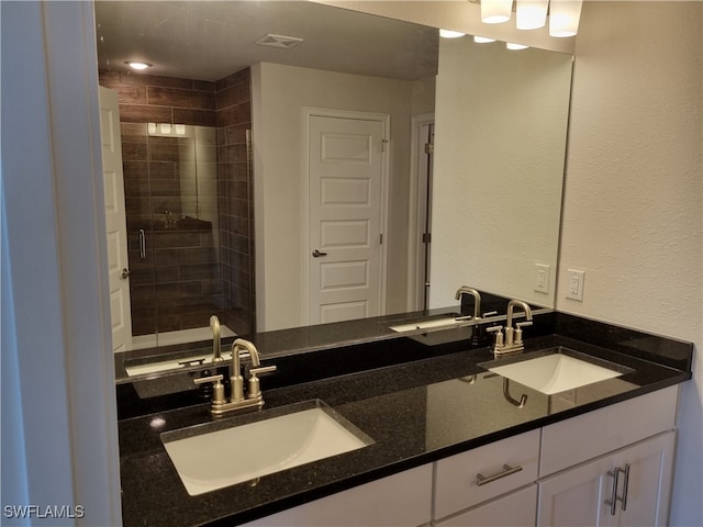 bathroom featuring vanity and a shower with door