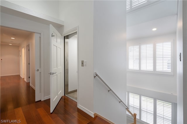 hall with dark wood-type flooring