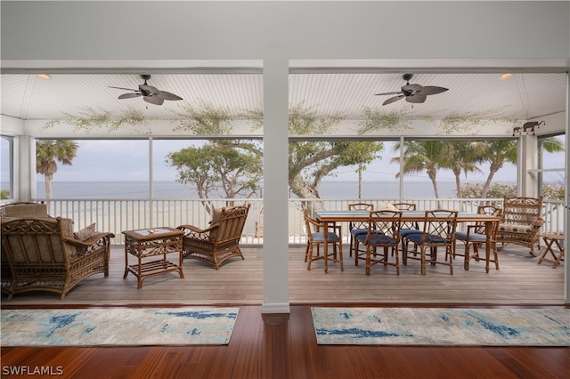 deck featuring an outdoor hangout area, ceiling fan, and a water view