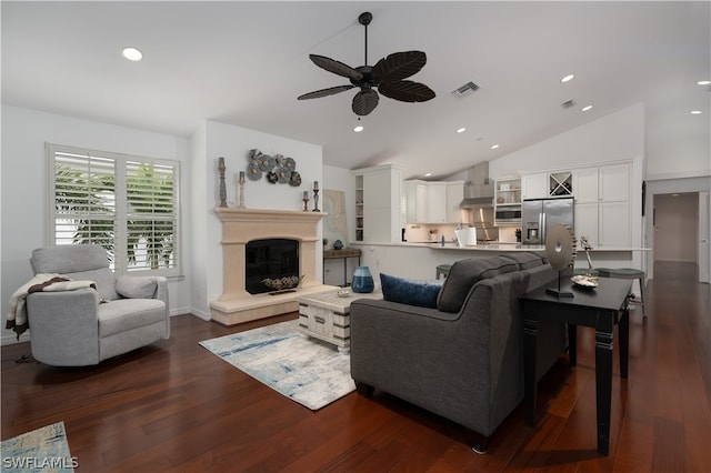 living room featuring ceiling fan, lofted ceiling, and dark hardwood / wood-style flooring