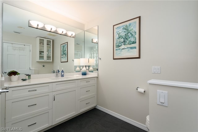 bathroom featuring vanity and toilet