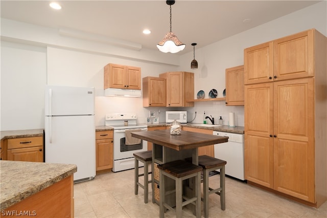 kitchen featuring white appliances, light brown cabinetry, hanging light fixtures, and backsplash