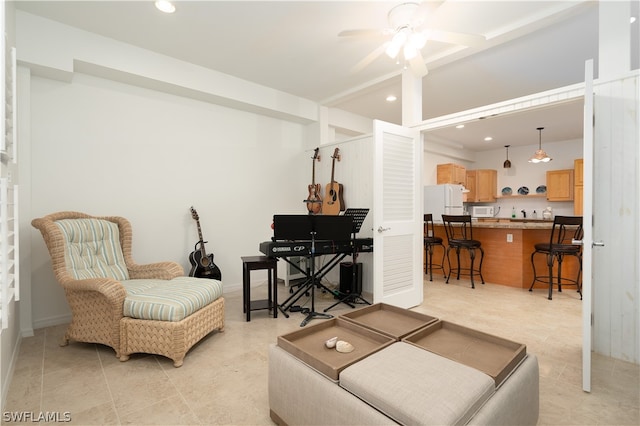 tiled living room with ceiling fan