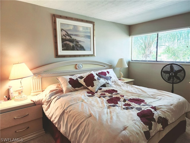 carpeted bedroom featuring a textured ceiling