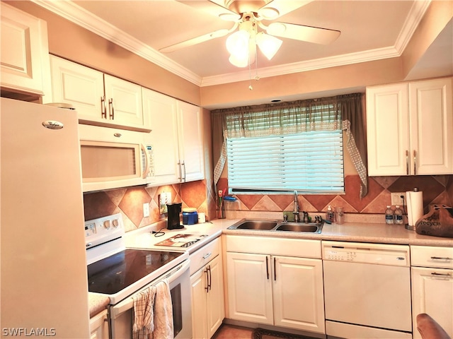 kitchen featuring white cabinets, sink, backsplash, and white appliances