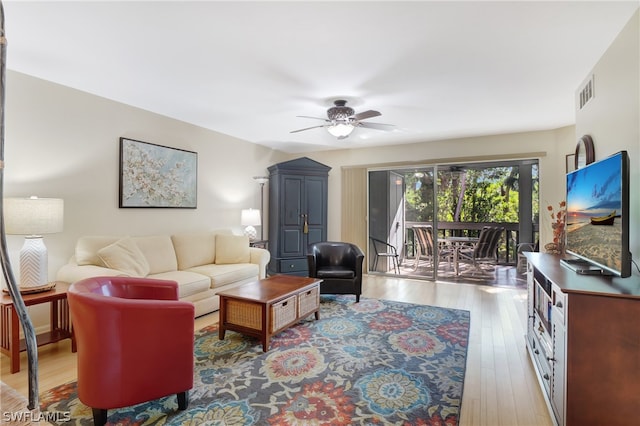 living room featuring light hardwood / wood-style flooring and ceiling fan