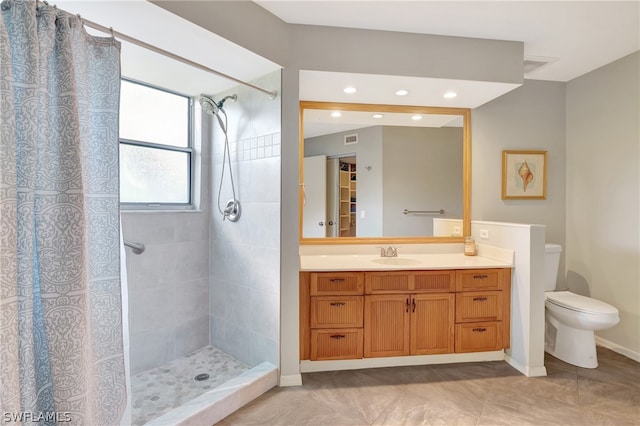 bathroom with toilet, vanity, tile patterned floors, and a shower with shower curtain