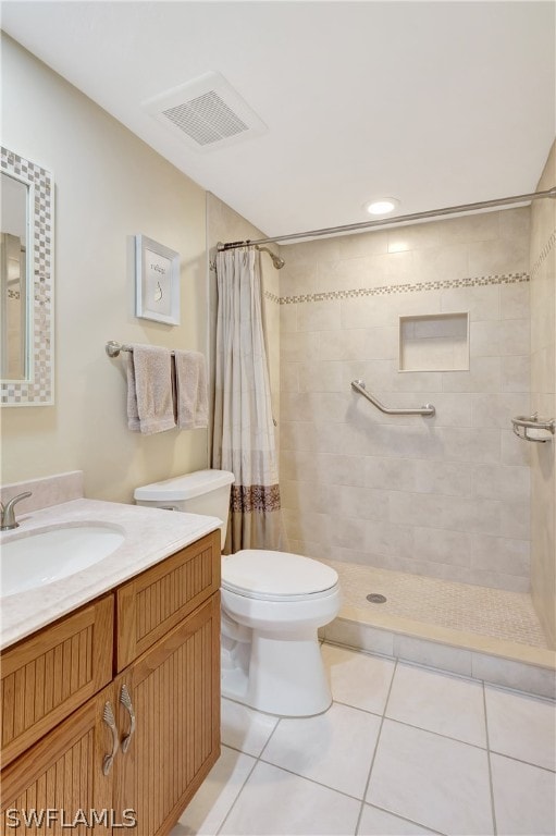 bathroom with vanity, curtained shower, toilet, and tile patterned flooring