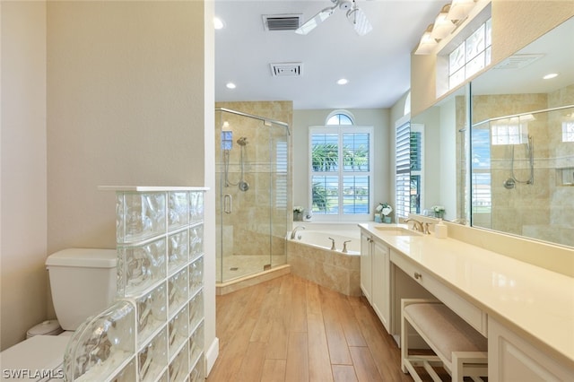 full bathroom with plenty of natural light, separate shower and tub, and ceiling fan