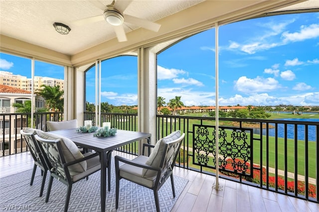 sunroom featuring ceiling fan