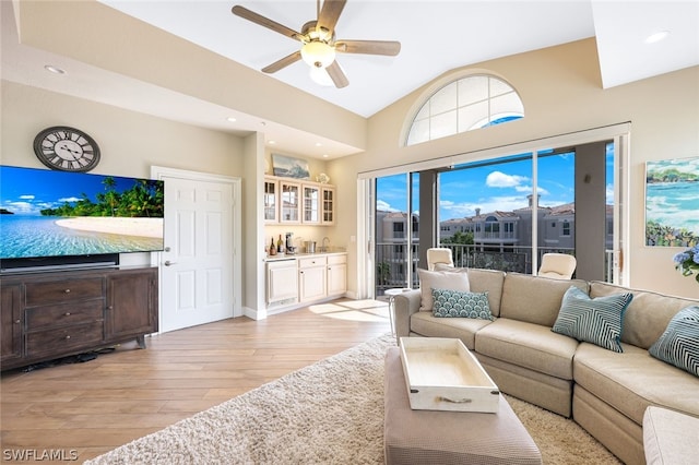 living room with ceiling fan and light hardwood / wood-style flooring