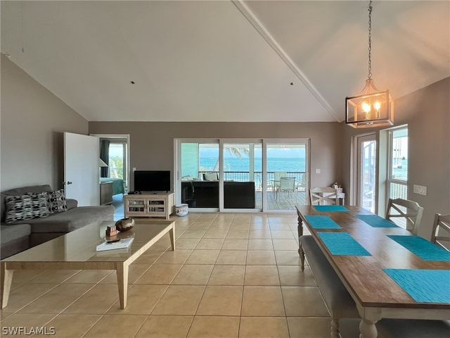 dining space featuring high vaulted ceiling, an inviting chandelier, light tile floors, and a wealth of natural light