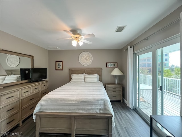 bedroom with access to exterior, ceiling fan, and dark hardwood / wood-style flooring