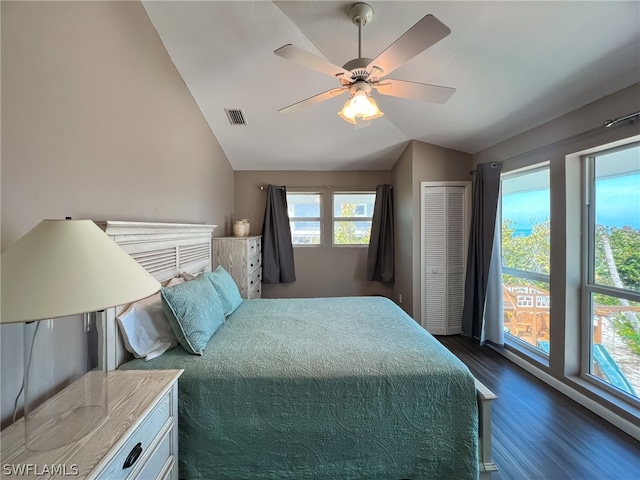 bedroom with lofted ceiling, a closet, ceiling fan, and dark hardwood / wood-style floors