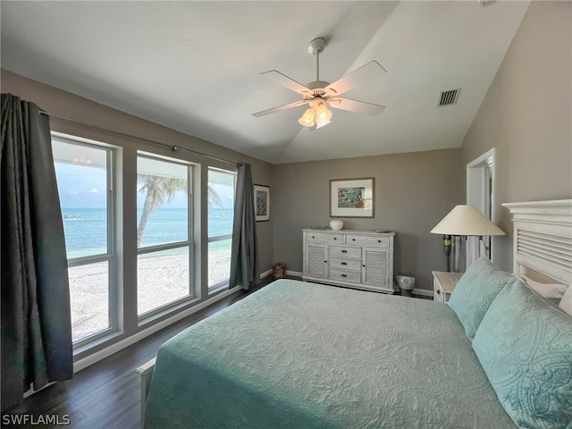 bedroom featuring a water view, vaulted ceiling, ceiling fan, and dark hardwood / wood-style floors