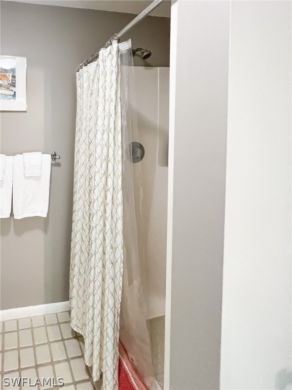 bathroom featuring curtained shower and tile floors