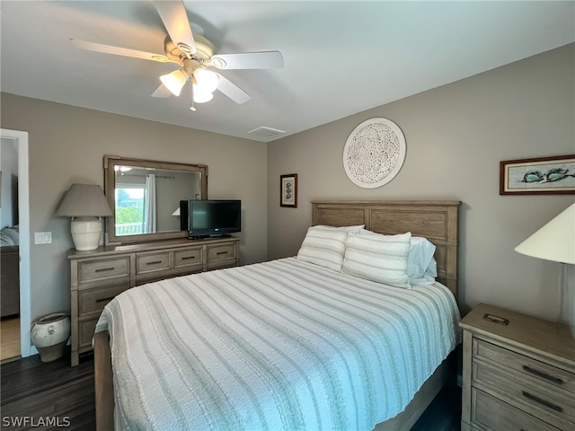 bedroom with ceiling fan and dark hardwood / wood-style flooring